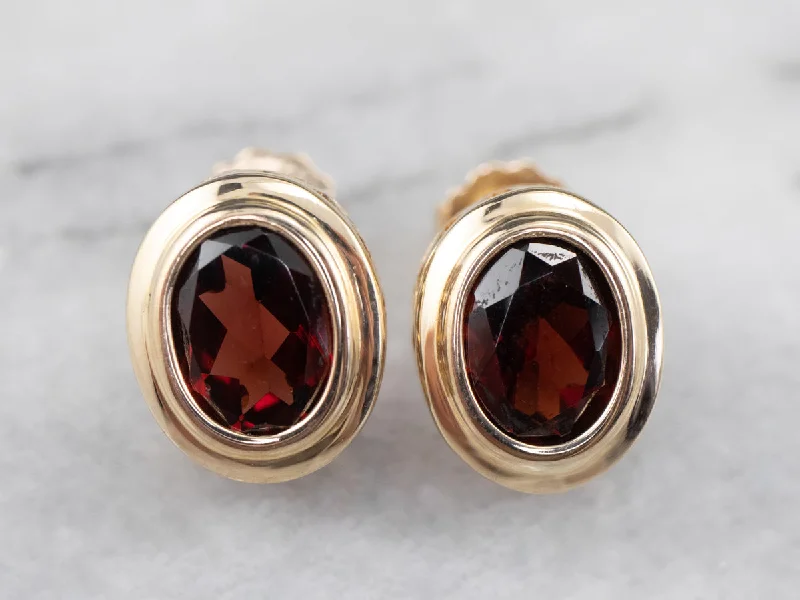 Women’s fancy earrings-Bezel Set Garnet Stud Earrings in Yellow Gold